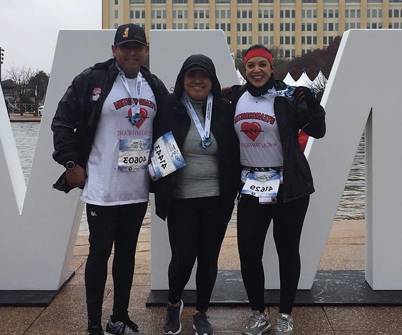 Christina proudly wears the medal she earned at her first 5K, crossing the finish line with friends Juanita and Rey. From left to right: Juanita Cano, Christina Herrera, and Rey Alvarez. (Photo courtesy of Juanita Cano)